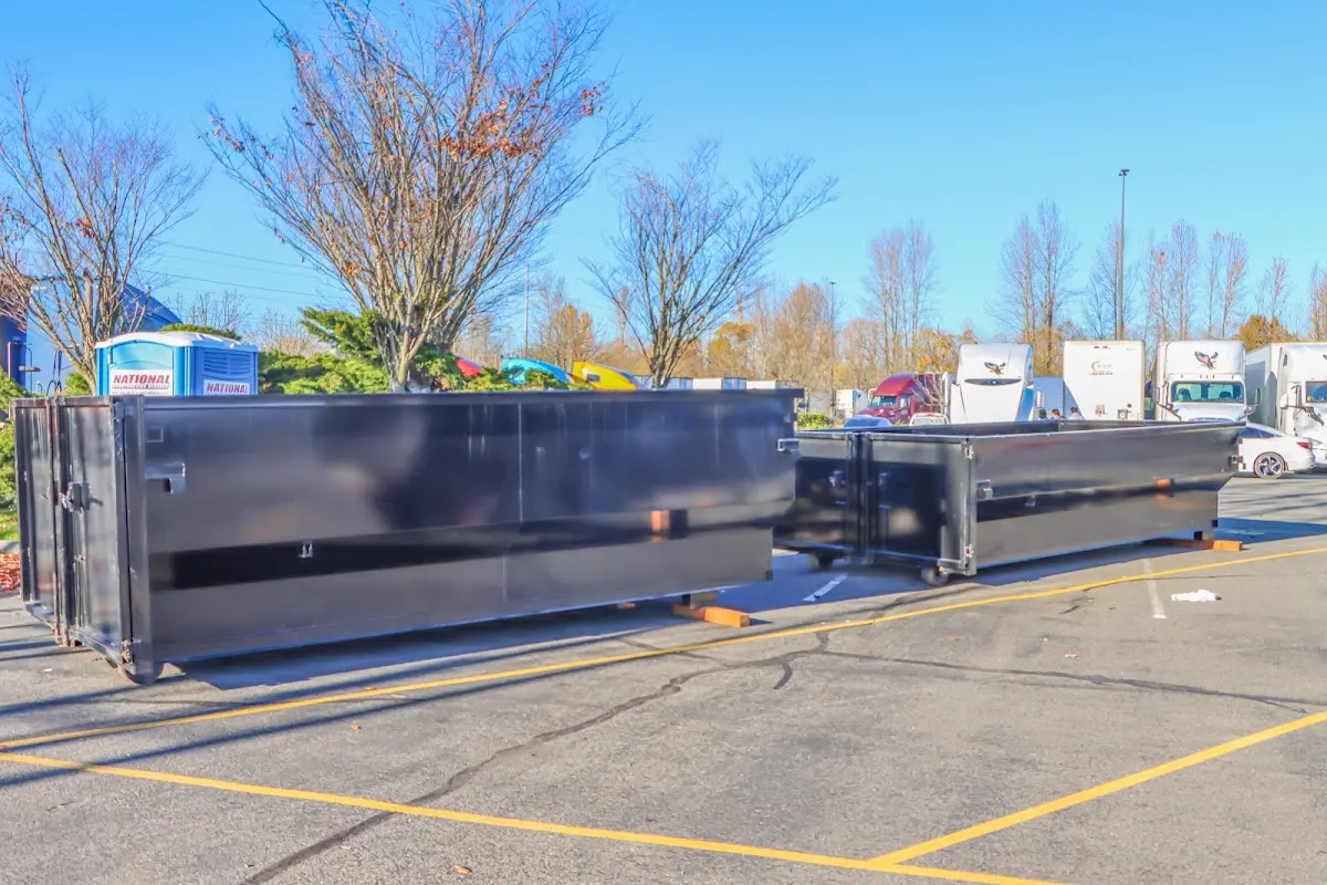 Professional dumpster rental service with roll-off container on residential driveway in Pearsall